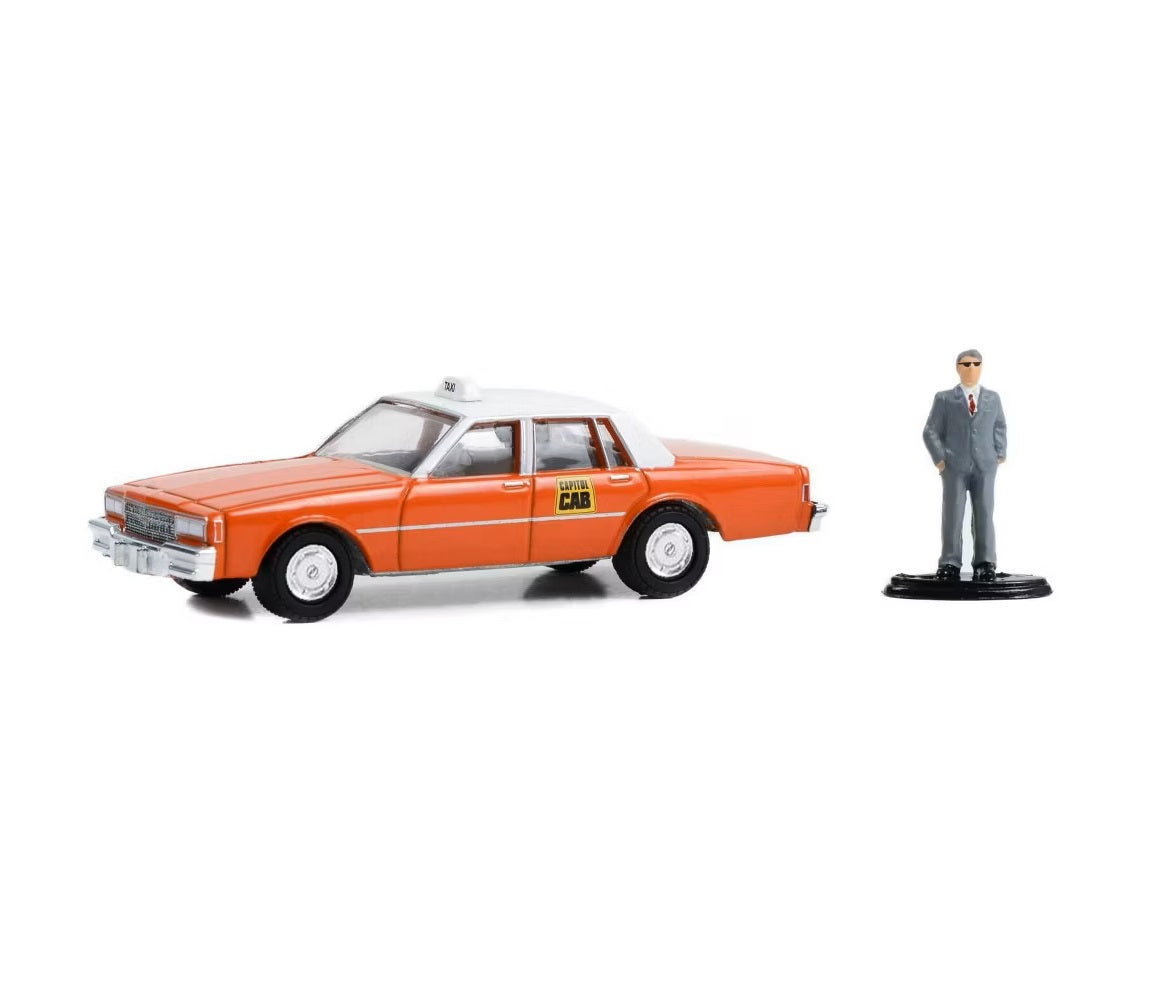 Greenlight - 1981 Chevrolet Impala "Capitol Cab" Taxi Orange with White Top and Man in Suit Figure - Series Hobby Shop - Scala 1/64