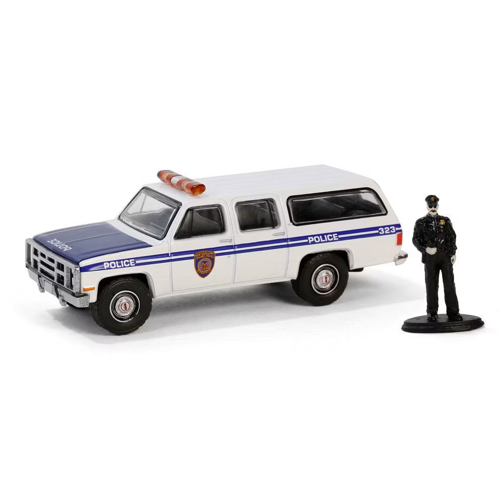 Greenlight - 1985 GMC Suburban 2500 NYC Transit Police with Police Officer Figure - Series Hobby Shop - Scala 1/64