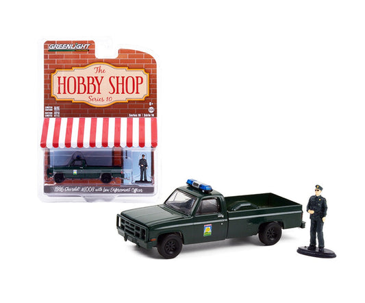 Greenlight - 1986 Chevrolet M1008 with Enforcement Officer Figure Series Hobby Shop - Scala 1/64